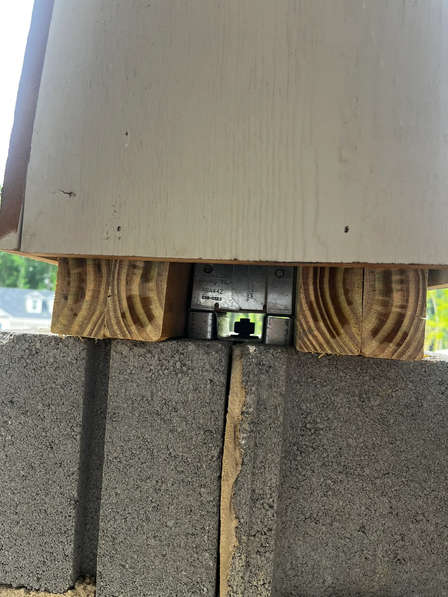 Loose anchor bolt nut discovered during porch pier repair — unscrewed on its own